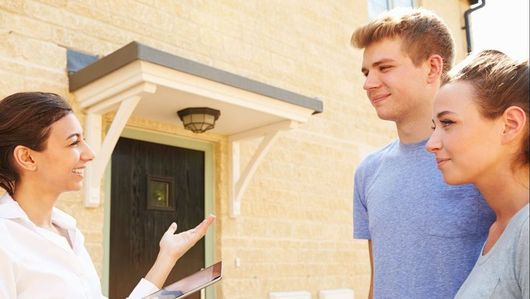 Letting Agent showing young couple around house